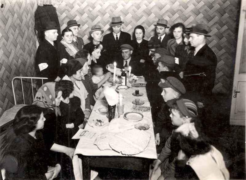 1941 A man can be seen breaking a matzah during a Passover Seder held at a refugee shelter run by the Osternhilfswerk relief committee at 6 Leszno Street in the Warsaw Ghetto Poland Likud Brasil